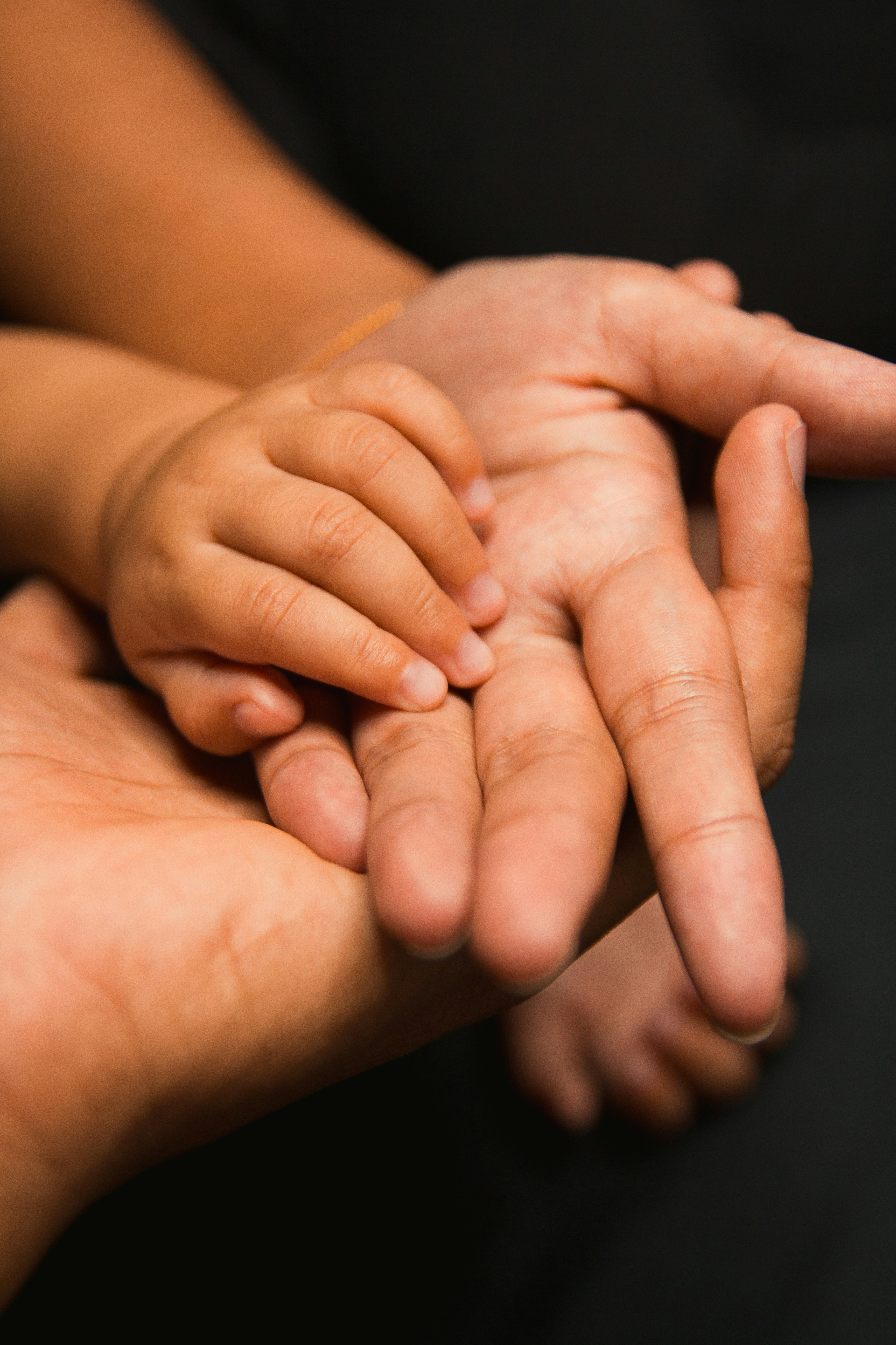 A parent and child's hands together